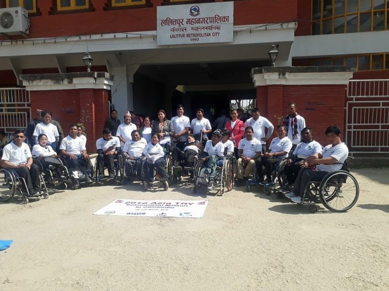 a group of wheelchair user infront of Lalitpur Metropolitian office building